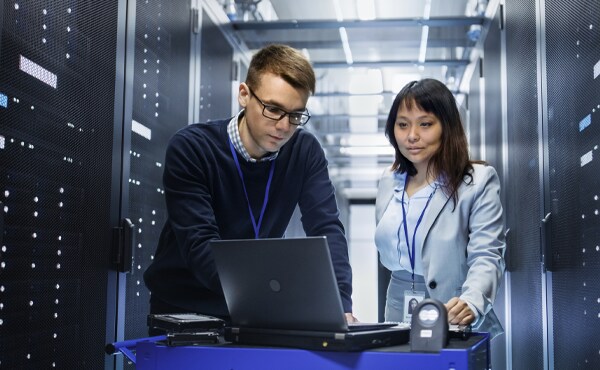 Two people working on a computer system