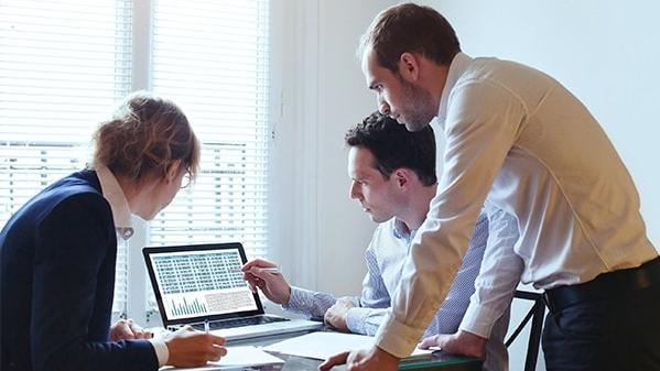 Team looking at data on a computer