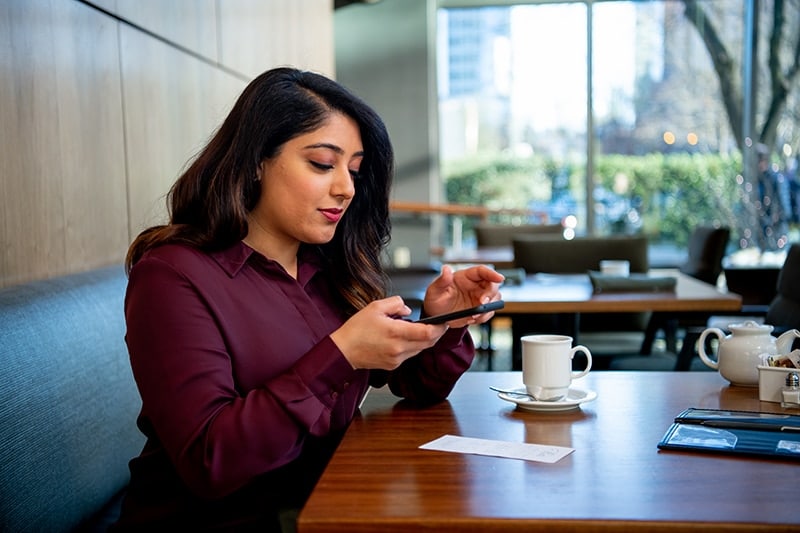 woman expensing with mobile phone